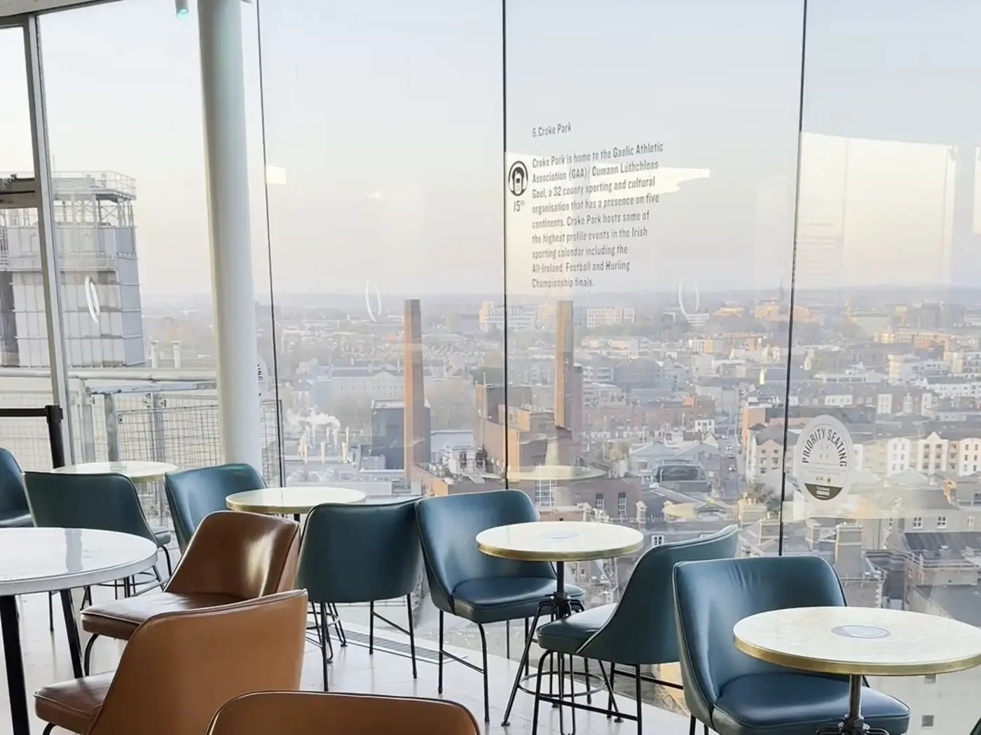 Modern city-view lounge with floor-to-ceiling windows and seating for gatherings