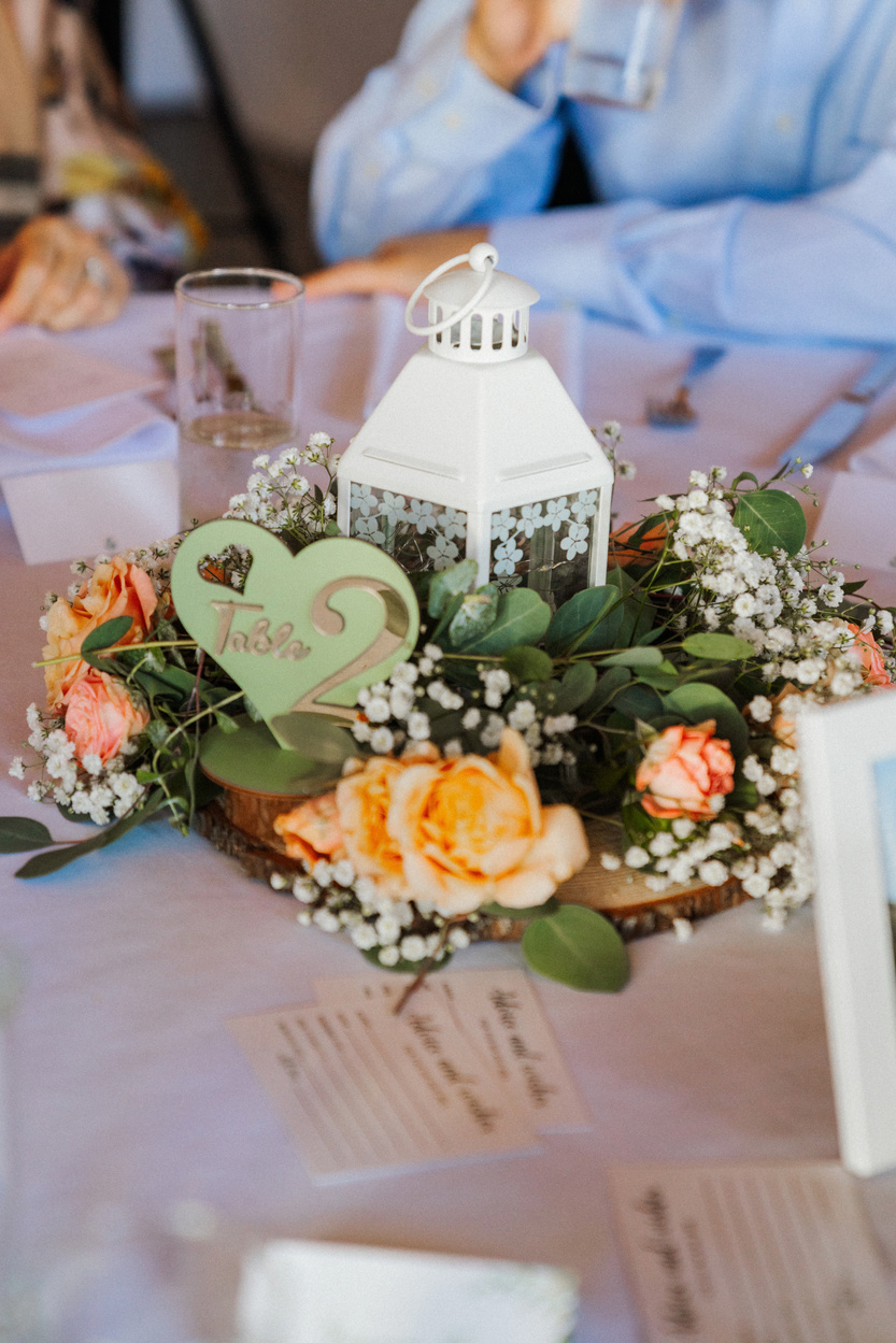A candlelit reception table with flowers and place settings